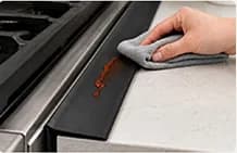 FlexBridge being wiped clean beside a stove