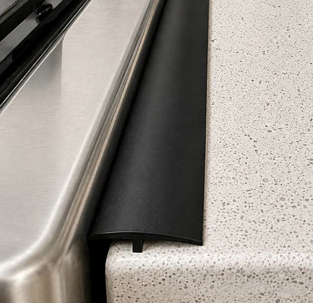 Ordinary flat gap cover beside a stove and countertop